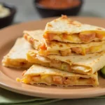 Golden and crispy chicken quesadilla filled with seasoned chicken, melted cheese, and fresh vegetables.