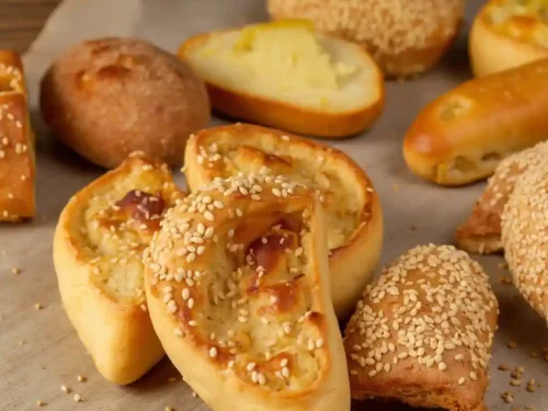 A variety of freshly baked breads and pastries, including croissants, muffins, and artisan loaves