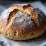 A freshly baked gluten free sourdough bread with a crispy crust and soft, airy inside.